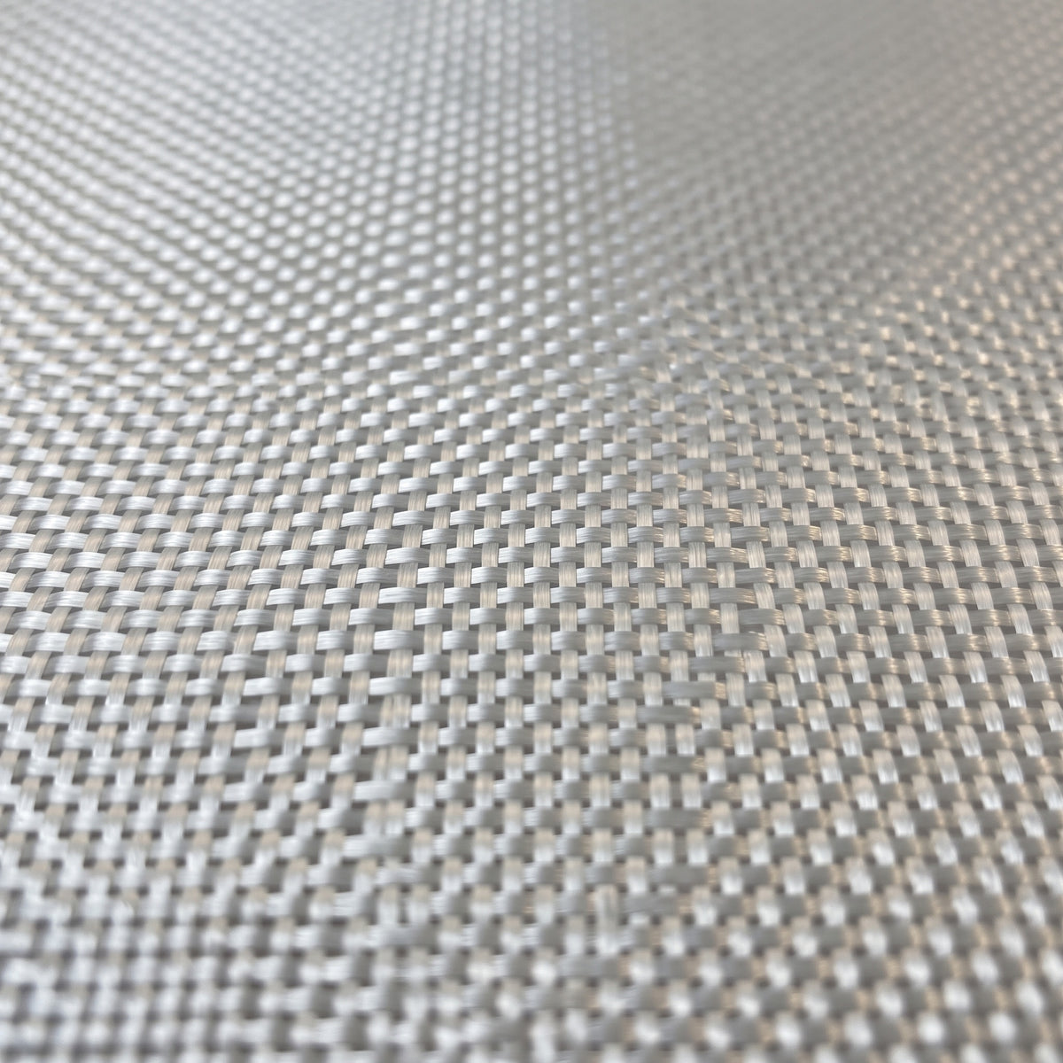 Close-up of 4 oz plain weave glass cloth, fine flat yarns crossing in an even square grid