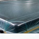 Translucent vacuum bagging film sealed over a composite layup under vacuum