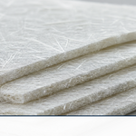 Stacked layers of white chopped strand mat fiberglass on a workbench