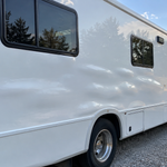 Fiberglass motorhome sidewall with several delamination bulges across a wide area
