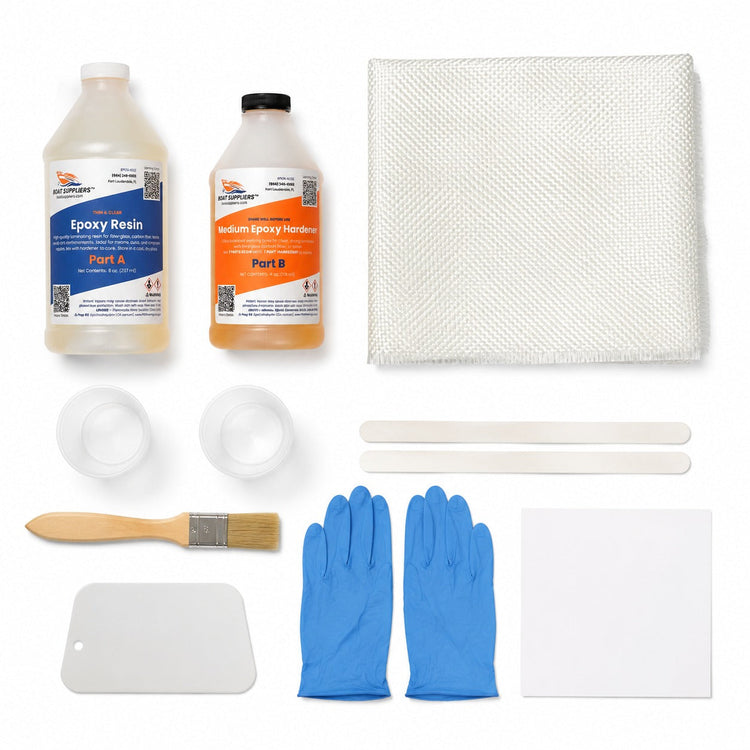Composites 101 student lab kit contents: two-part epoxy resin and hardener bottles, folded 6oz fiberglass cloth, mixing cups, sticks, chip brush, spreader, nitrile gloves and lab card