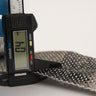 11 oz unidirectional carbon fiber tape thickness checked with a digital caliper in mm, tape curled on a white surface