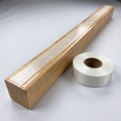 Wooden stringer reinforced with unidirectional fiberglass tape under cured resin