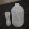 Real photo: 16 oz HDPE dispenser bottle with graduated measuring chamber removed, showing dip tube