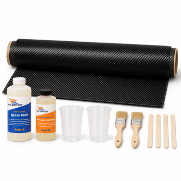 Carbon fiber skinning kit contents: full 50 inch roll width by 1 yard cut of 2x2 twill carbon fiber rolled on a tube, Boat Suppliers thin clear epoxy resin Part A and slow epoxy hardener Part B bottles, graduated mixing cups, chip brushes and stir sticks