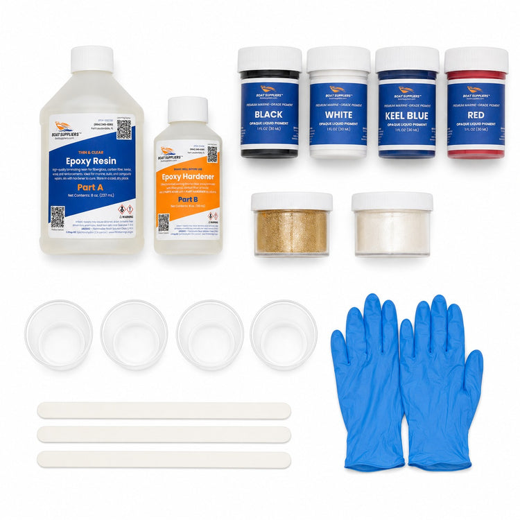 Resin art starter kit contents: two-part epoxy resin and hardener, four opaque liquid pigments in black white keel blue and red, gold and pearl mica powders, mixing cups, sticks and gloves