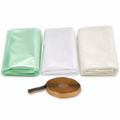 Vacuum bagging consumables kit laid out on white: folded translucent green nylon bagging film, white peel ply release fabric, off-white breather cloth and one roll of yellow sealant tape on its paper backing