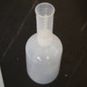 Real photo: assembled dispenser bottle with cylindrical graduated measuring chamber