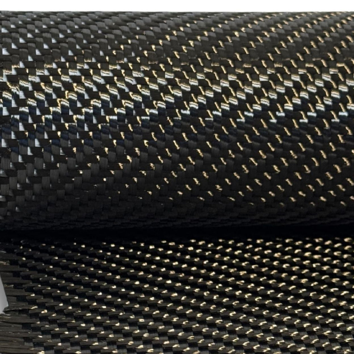 19.7 oz 2x2 twill carbon fiber on the roll with a length draped below, the heavy 12K weave catching the light across both layers