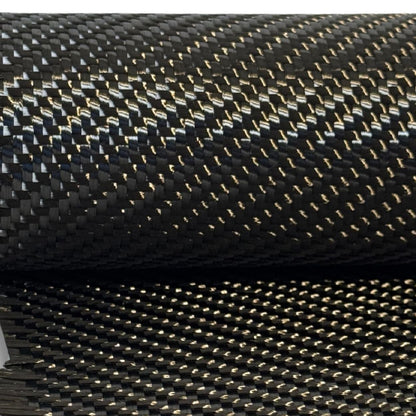 19.7 oz 2x2 twill carbon fiber on the roll with a length draped below, the heavy 12K weave catching the light across both layers