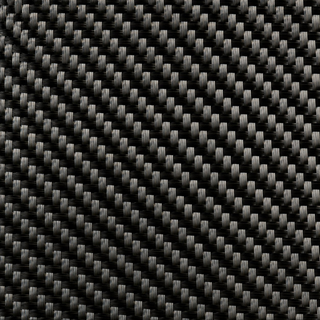 Macro close-up of 5.7 oz 3K carbon fiber 2x2 twill weave showing tow structure and sheen