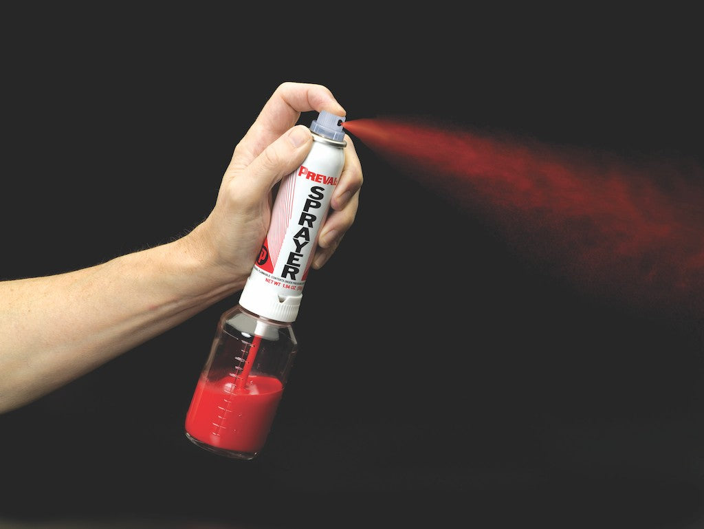 Preval power unit atomizing red paint in a fine spray pattern