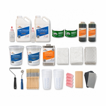 Pro fiberglass mold making kit contents: orange tooling gelcoat and 404 isophthalic tooling resin gallons with MEKP, two Partall #2 paste wax, two PVA mold release, chopped strand, fumed silica, a pint of surfacing wax, veil mat, chopped strand mat and woven roving, two rollers, chip brushes, pint mixing tubs, release wedges, mixing sticks and sandpaper