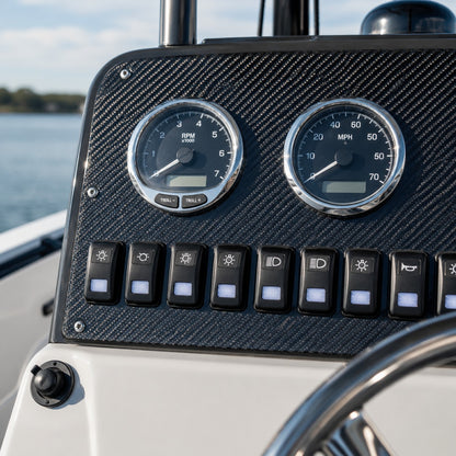 Boat helm dash panel skinned in 2x2 twill carbon fiber with gauges and switches installed